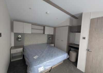 Willerby Salisbury master bedroom with king-size bed, vanity area and fitted storage