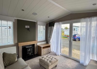 2026 Swift Vendee Lodge lounge with freestanding sofas and electric stove