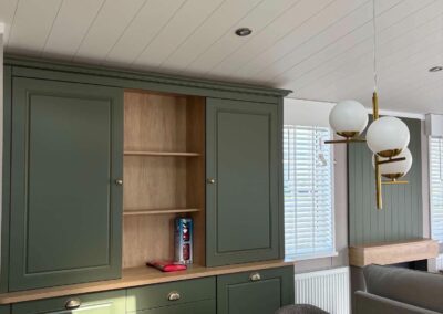 2026 Swift Vendee Lodge dining area with green cabinetry and oak finishes